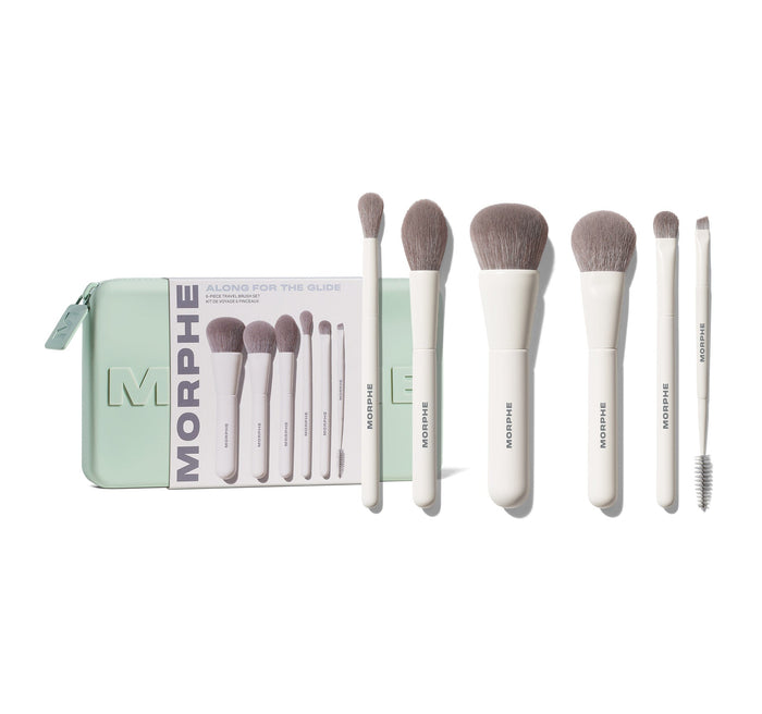 Morphe Along For The Glide 6-Piece Travel Brush Set: mint zip case reading "MORPHE ALONG FOR THE GLIDE 6-PIECE TRAVEL BRUSH SET KIT DE VOYAGE 6 PINCEAUX" displayed alongside six white-handled taupe-bristled Morphe brushes and a spoolie.