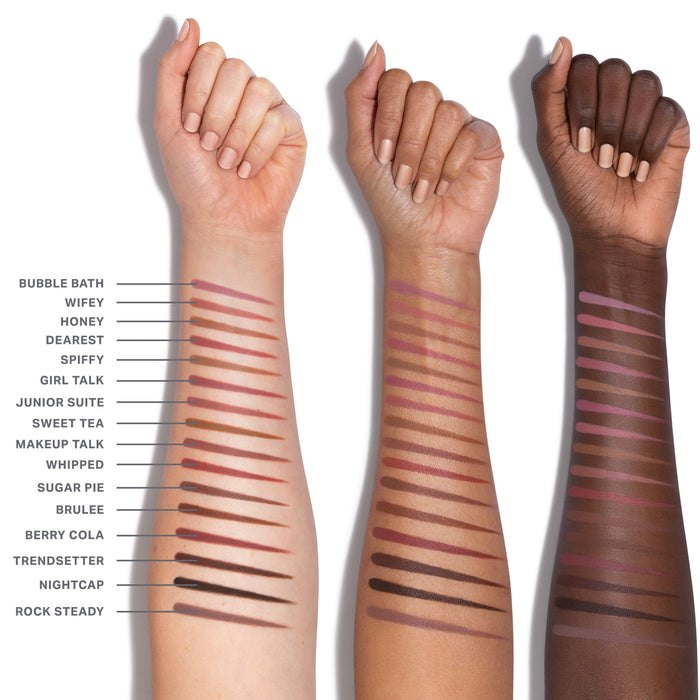 Signature Lip Pencil arm swatches across three skin tones showing shades Bubble Bath, Wifey, Honey, Dearest, Spiffy, Girl Talk, Junior Suite, Sweet Tea, Makeup Talk, Whipped, Sugar Pie, Brulee, Berry Cola, Trendsetter, Nightcap, and Rock Steady.
