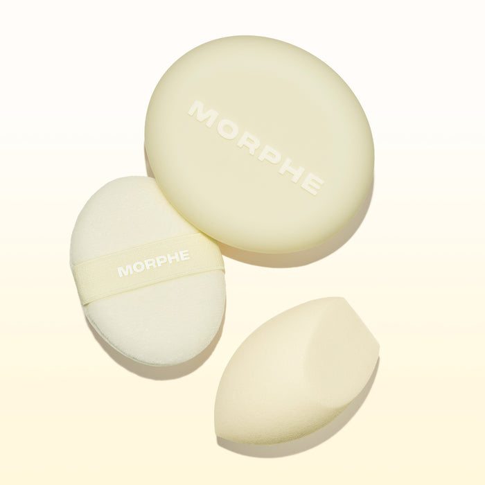 Morphe Buttery Blends Tool Duo stylized group shot showing a round MORPHE powder puff, a MORPHE-branded oval sponge with strap, and a teardrop blending sponge.