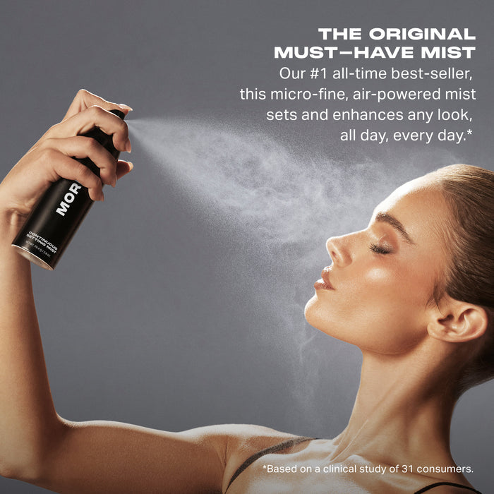 Morphe Continuous Setting Mist black spray can misting toward a model's face; text reads "THE ORIGINAL MUST–HAVE MIST Our #1 all-time best-seller, this micro-fine, air-powered mist sets and enhances any look, all day, every day.*"