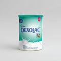 A tin of Nutricia Dexolac infant formula, 400gm size, with branding and decorations visible.