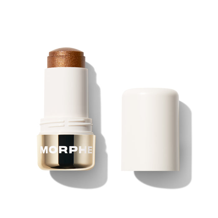 {Sunset Blvd.} Morphe Dreamlight Gelee Highlighter Stick in a warm bronze shade, open stick with cap beside it, gold band reading MORPHE.