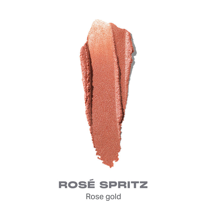 {Rose Spritz} Dreamlight Gelee Highlighter Stick shade swatch in rose gold with text "ROSÉ SPRITZ — Rose gold."