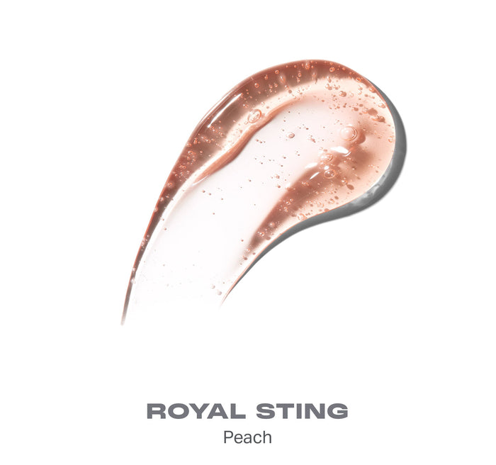 {Royal Sting} Swatch of Morphe Hot Honeys Plumping Lip Oil in shade ROYAL STING Peach; shiny peachy-rose liquid with visible oil bubbles