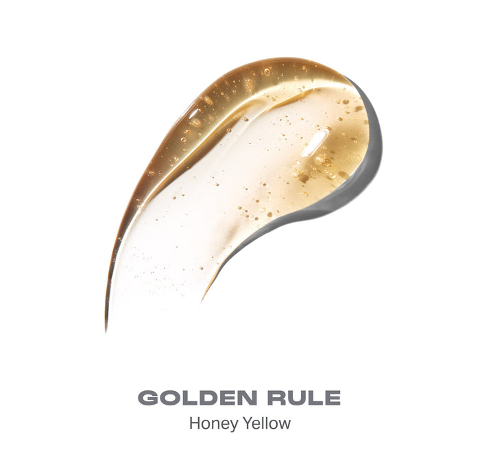 {Golden Rule} Swatch of Hot Honeys Plumping Lip Oil in GOLDEN RULE Honey Yellow shade, glossy honey-colored formula with shimmer particles.