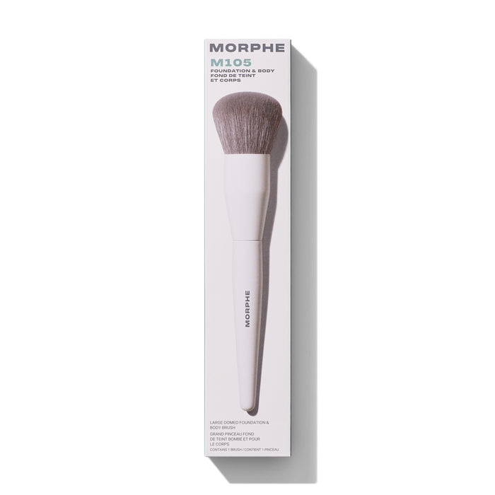 Morphe M105 Large Domed Foundation & Body Brush in white packaging labeled "MORPHE M105 FOUNDATION & BODY FOND DE TEINT ET CORPS" with taupe domed bristles and "MORPHE" on the handle.