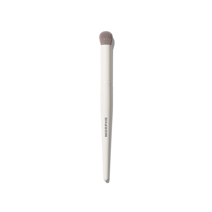 Morphe M133 Domed Concealer Brush with cream white handle printed with MORPHE and soft gray domed bristles on white background.