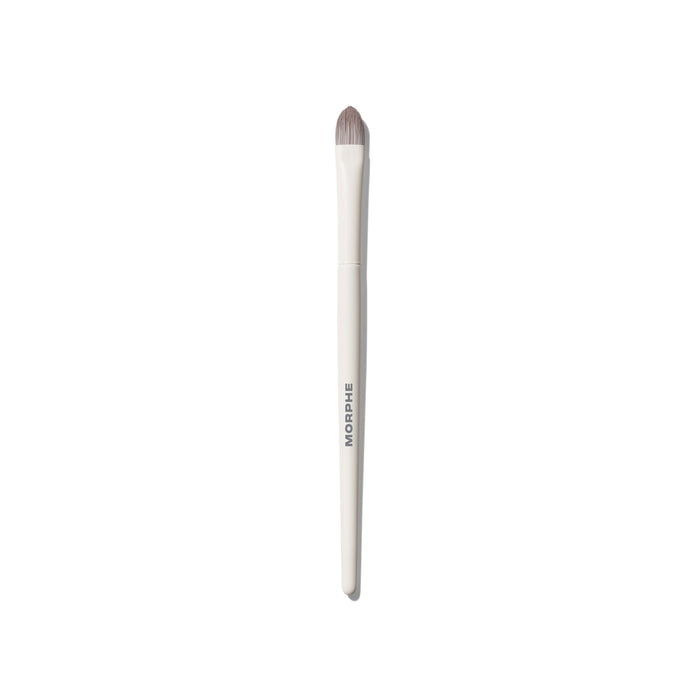 Morphe M134 Pointed Paddle Concealer Brush with cream handle and dense pointed taupe synthetic bristles, MORPHE engraved on shaft.
