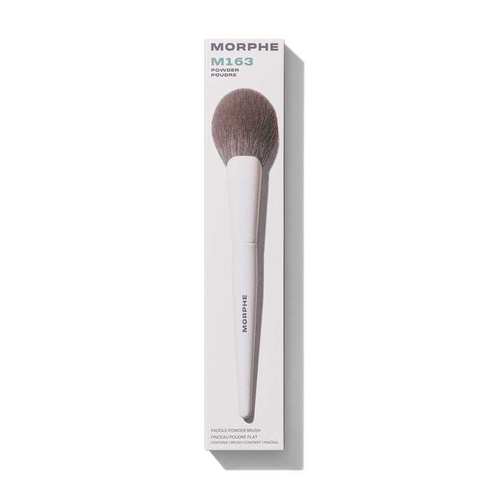 Morphe M163 Paddle Powder Brush in white packaging labeled "MORPHE M163 POWDER POUDRE PADDLE POWDER BRUSH PINCEAU POUDRE PLAT CONTAINS 1 BRUSH/CONTIENT 1 PINCEAU."