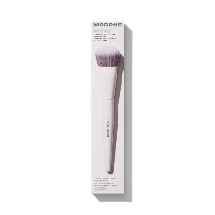 Morphe M242 Slanted Cream & Liquid Bronzer Brush in white packaging labeled "MORPHE M242 CREAM & LIQUID BRONZER / BRONZER CRÈME ET LIQUIDE / SLANTED CREAM & LIQUID BRONZER BRUSH / PINCEAU INCLINÉ POUR BRONZER CRÈME ET LIQUIDE / CONTAINS 1 BRUSH / CONTIENT 1 PINCEAU."