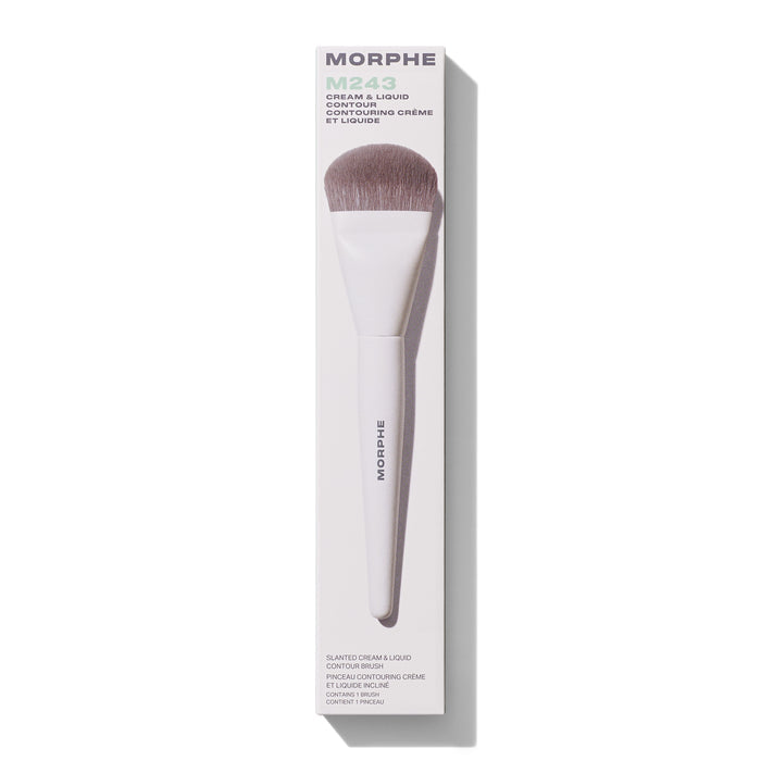 Morphe M243 Slanted Cream & Liquid Contour Brush with white handle and taupe bristles shown next to box reading "MORPHE M243 CREAM & LIQUID CONTOUR SLANTED CREAM & LIQUID CONTOUR BRUSH CONTAINS 1 BRUSH."