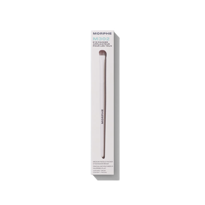 M302 Medium Paddle Packer Eyeshadow Brush shown beside its cream MORPHE retail box for lid color payoff.