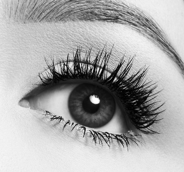Black-and-white close-up of eye with thick voluminous Morphe Make It Big Volumizing Mascara lashes.