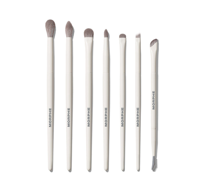 Eye Want It All 7 Piece Eye Brush Set featuring seven white-handled MORPHE brushes with gray bristles, ranging from large dome to angled liner and dual-ended spoolie.