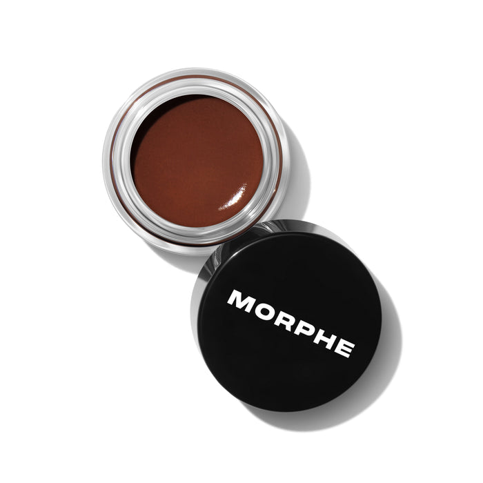 {Almond (warm brown)} Morphe Supreme Brow Sculpting and Shaping Wax in Almond, open clear glass jar showing warm brown wax beside black lid labeled MORPHE.