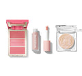 Morphe Ultimate Glow Trio with open MORPHE-engraved blush compact showing three rosy pink shades, a MORPHE lip gloss with applicator, and a clear highlighter compact with embossed M logo.