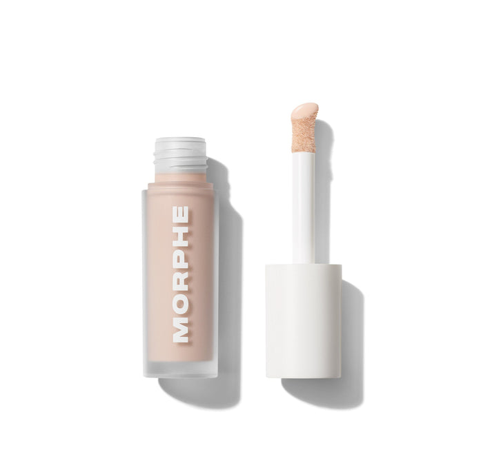 {Porcelain 2c} Morphe Wakeup Artist Under Eye Correcting Concealer labeled MORPHE open with white doe-foot applicator in light peachy tone on white background.